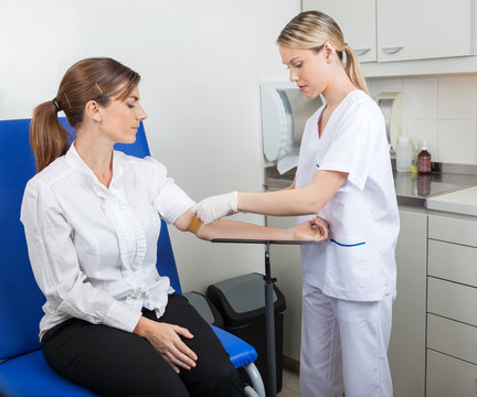 Nurse Preparing Businesswoman For Blood Test