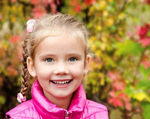 Autumn portrait of cute smiling little girl