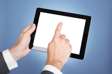 Hand pointing at tablet computer screen