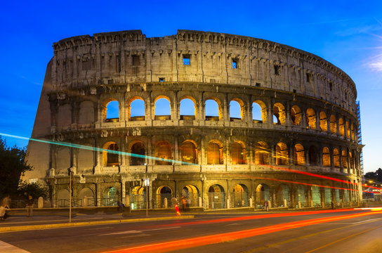Night view of Colosseum with traffic lights in Rome, Italy