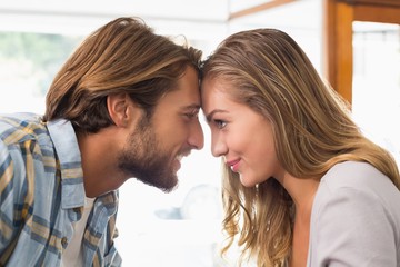 Happy couple touching their heads