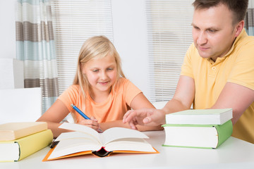 Fototapeta na wymiar Father Helping Daughter With Homework
