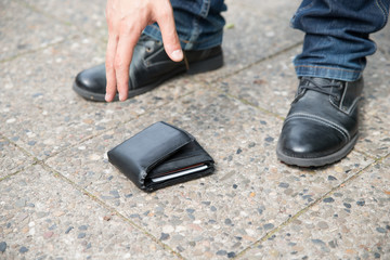 Man Picking Up Fallen Wallet