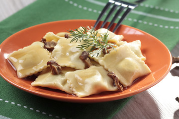Portion of ravioli with mushrooms and sauerkraut