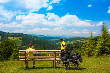 Two bicyclist in sunny mountain landscape