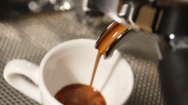 espresso being poured from a proffesional espresso machine
