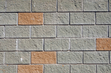The wall of the large gray and red rectangular stones as backgro