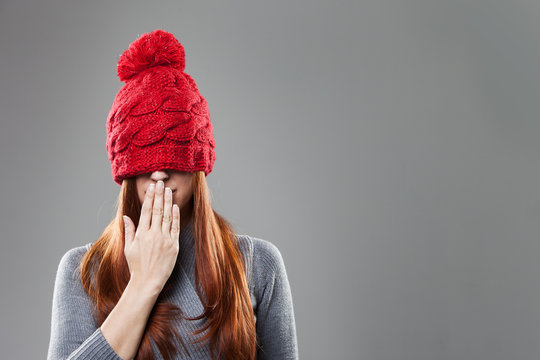 Woman Covering Eyes with Red Bonnet