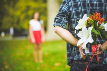 Man ready to give flowers to girlfriend