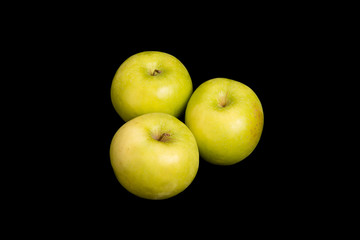 Three Granny Smith Apples on Black Background