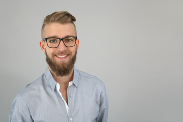 Portrait of trendy guy looking at camera, isolated