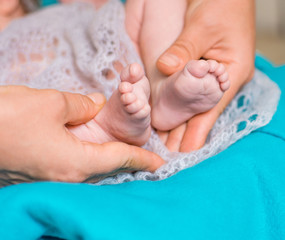 baby feet on female hands