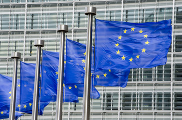 EU flags in front of European Commission in Brussels - obrazy, fototapety, plakaty