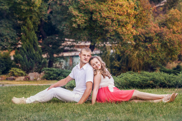 Loving couple on the lawn in park