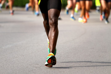 runner with sneakers during the Marathon on road