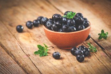 Blueberries in a bowl on a beautiful rustic table
