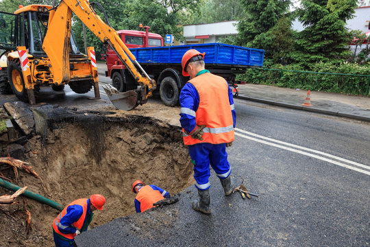 Workers repairing the damaged road