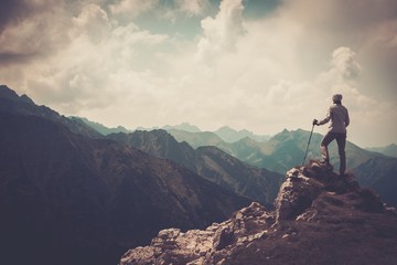 Woman hiker on a top of a mountain - obrazy, fototapety, plakaty