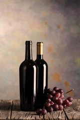 Wine bottles on wood floor and grunge background