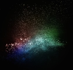 Colourful powder exploding isolated on black