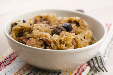 traditional polish sauerkraut (bigos) with mushrooms and plums
