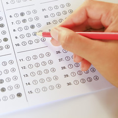 Standardized test form with answers bubbled in and a pencil, foc