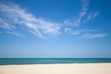 Beautiful cloudy sky over white sandy beach. Nature background