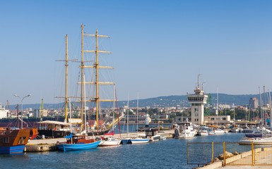 Big sailing ship and pleasure boats stand moored in Varna Port