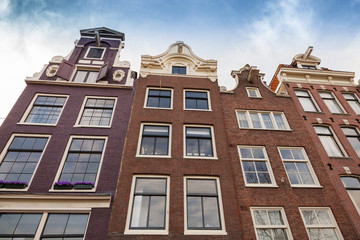 Living houses facades with blue sky. Amsterdam, Netherlands