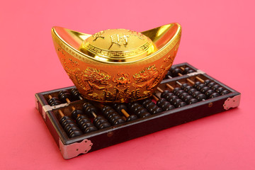 Chinese gold ingot and abacus mean symbols of wealth and prosper