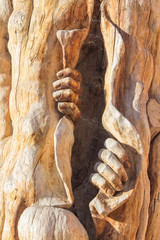 sculpture man emerging from inside a tree