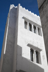 Fototapeta na wymiar White wall and blue sky. Madina, old part of Tangier, Morocco