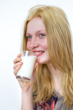 Blond girl drinking glass of milk