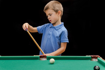 Fototapeta premium Beautiful boy playing billiard (pool)