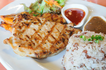 Chicken spicy and pock grilled with sauces and brown rice.