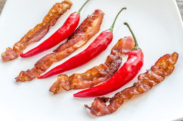 Fried bacon strips with chili pepper