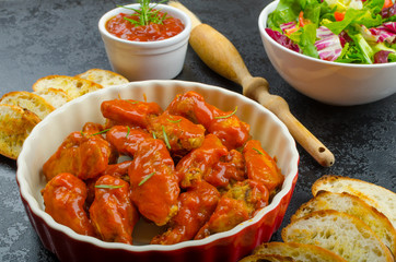 Hot chicken wings, habanero souce, salad