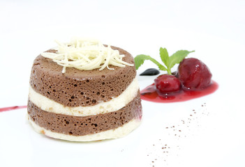 piece of cream cake decorated with chocolate and mint