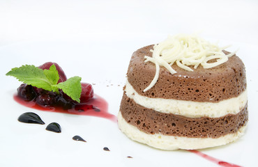 piece of cream cake decorated with chocolate and mint