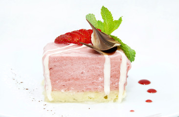 piece of cream cake decorated with chocolate and mint