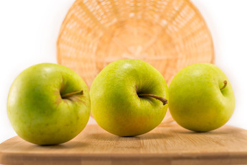 green apples lying on a cutting board