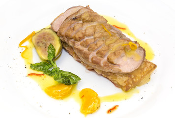 goose breast with vegetables on a white plate