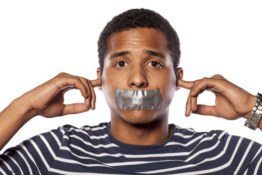African man with closed ears and adhesive tape over his mouth - Powered by Adobe