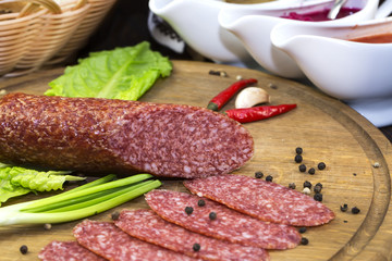 sausages on a wooden plate with vegetables in a restaurant