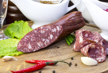 sausages on a wooden plate with vegetables in a restaurant