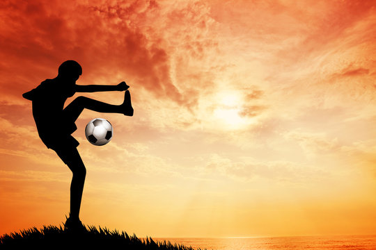 Footballer silhouette at sunset