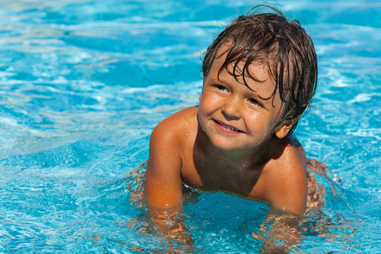 Close up view of smiling boy in swimming pool