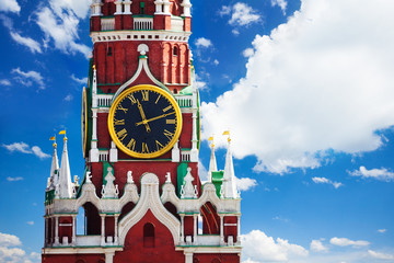 Kremlin Spasskaya tower clock over sky with clouds