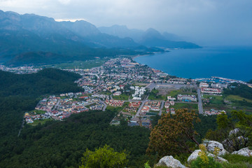 Aerial view of Kemer town with seashore and big mountains on a b