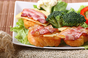 Serving breakfast toast with bacon and herbs